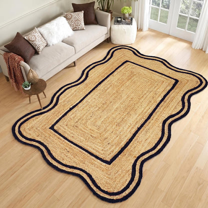 Natural Jute Area Rug with scalloped edges and navy blue trim in a cozy living room setting