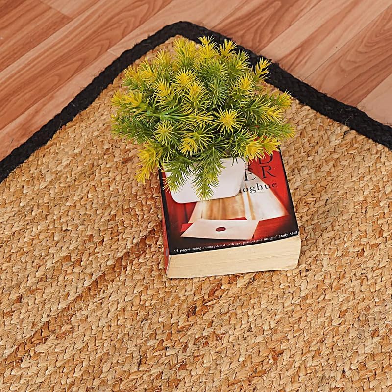 Natural Jute Area Rug Round Rug in natural jute with black border on hardwood floor