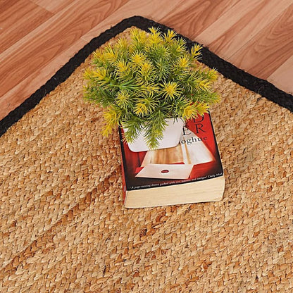 Natural Jute Area Rug Round Rug in natural jute with black border on hardwood floor