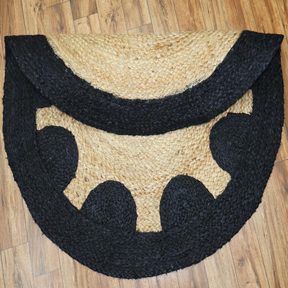 Black and beige half-circle rug on a wooden floor