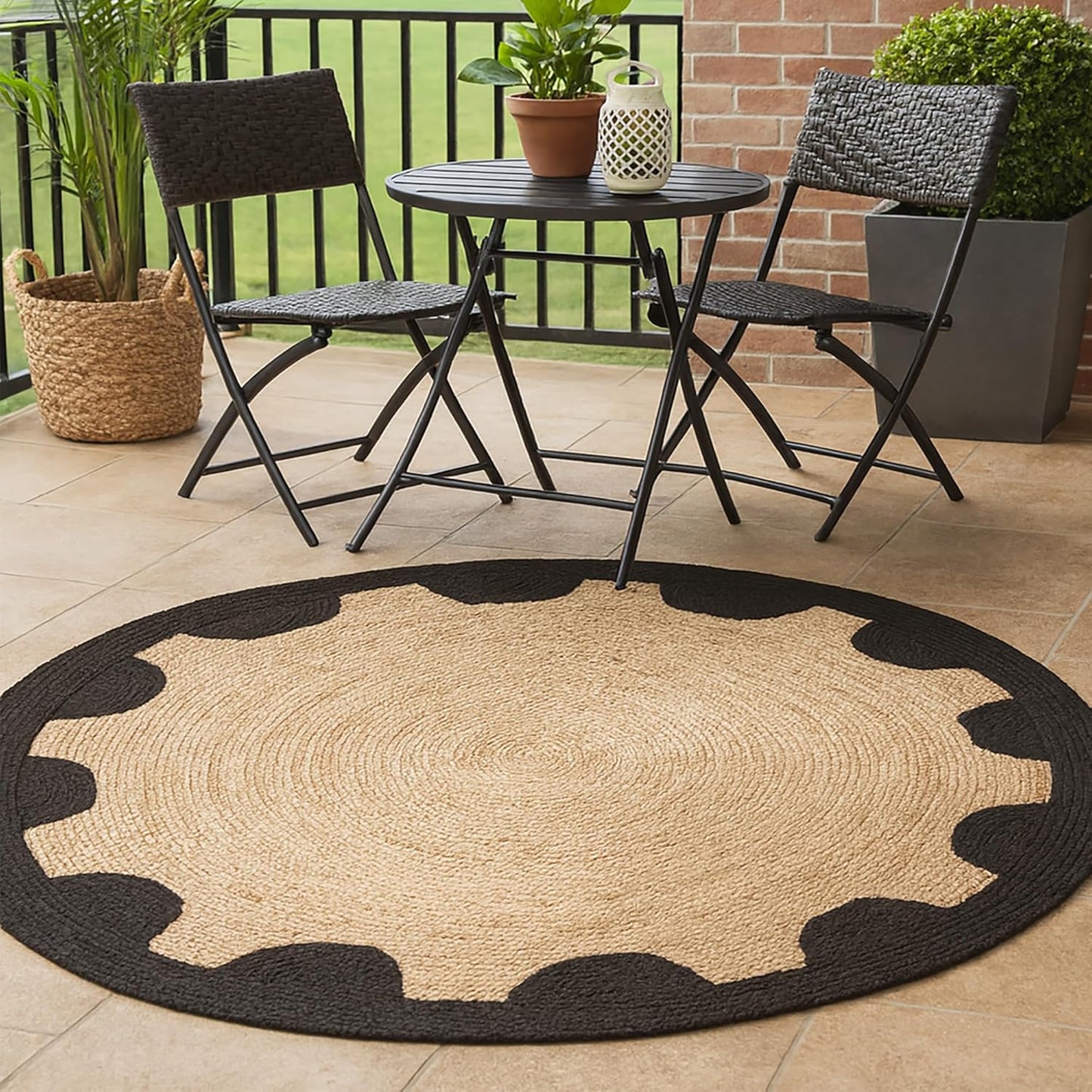 Round jute rug with black border on a patio with chairs and table.