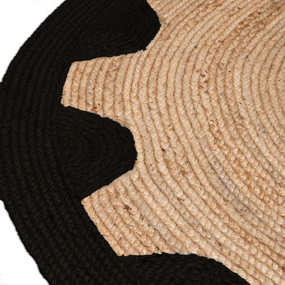 Close-up of a black and beige woven mat with concentric circle pattern