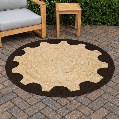 Round jute rug with black border on a patio with outdoor furniture.