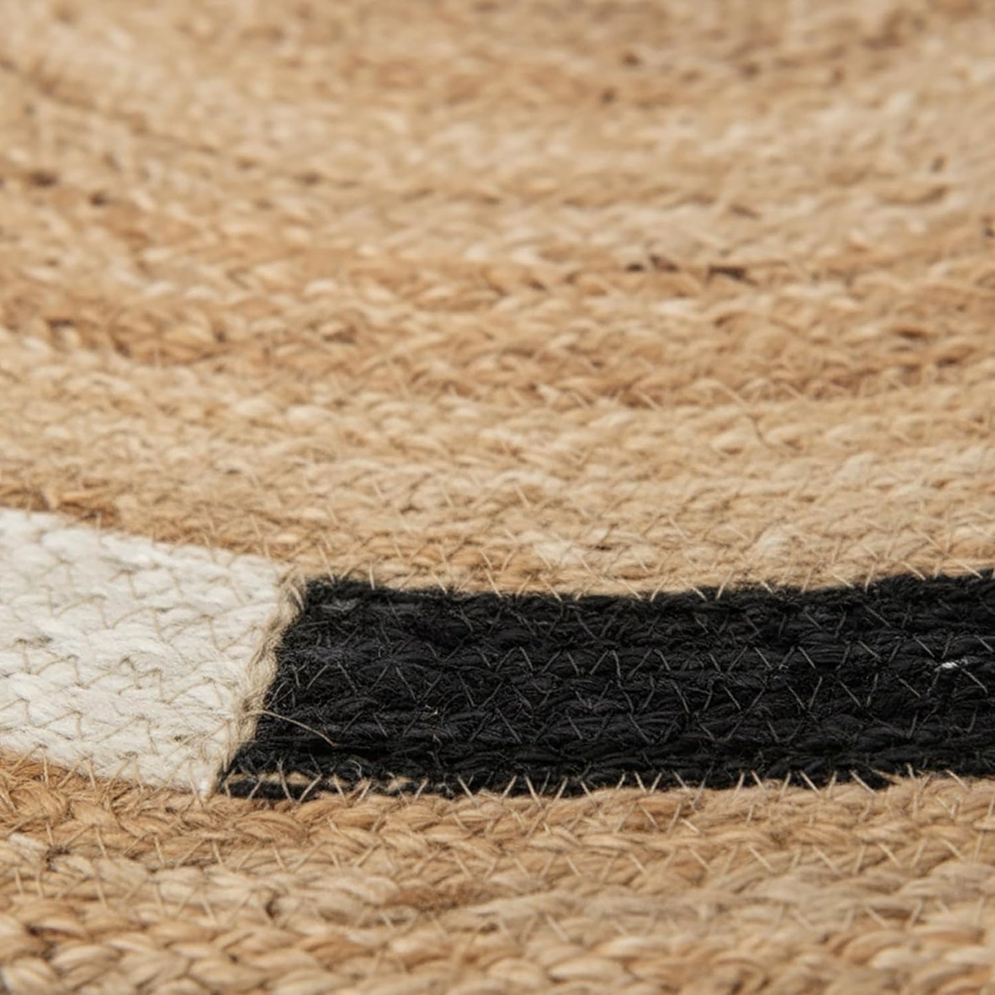 Natural jute area rug featuring black and white striped patterns, ideal for bohemian decor.
