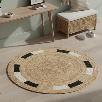 Round jute rug with black and white accents, eco-friendly material, perfect for modern living spaces.
