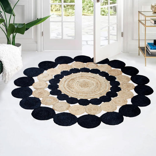 Round jute rug with black border in a room with white walls and a plant.