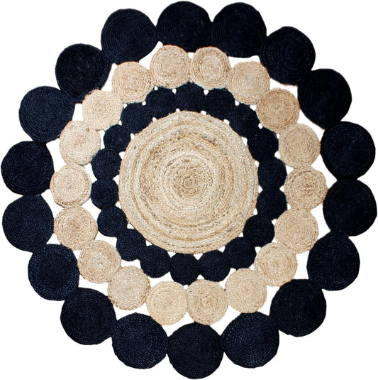 Round rug with concentric circle pattern of black and beige circles on a white background