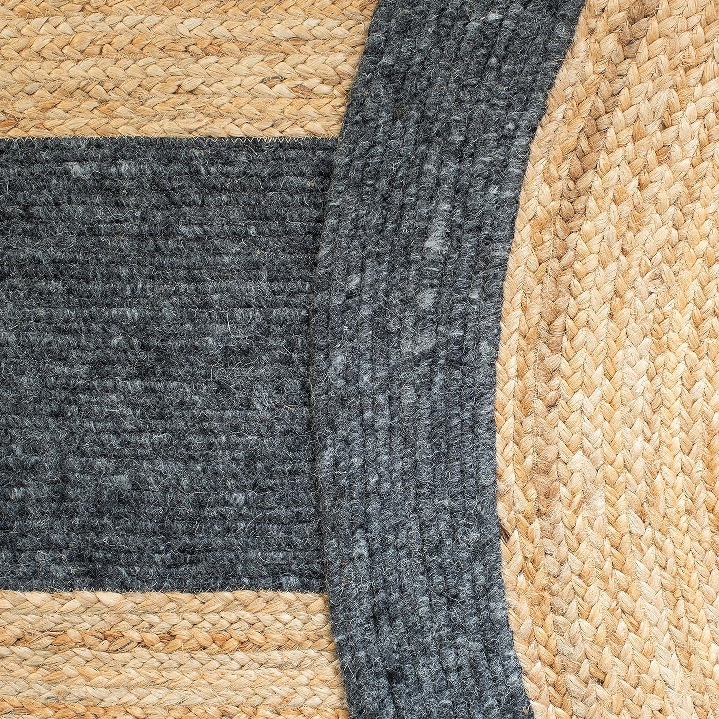 Round braided jute rug with gray wool accents, natural fibers, stylish home decor.