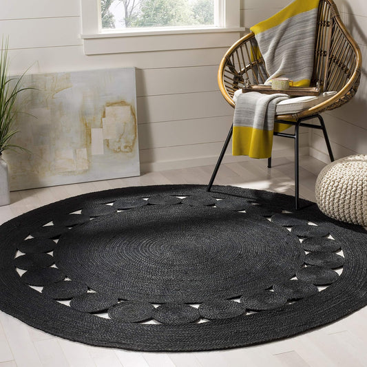 Black round braided rug with circular pattern, perfect for modern home decor.