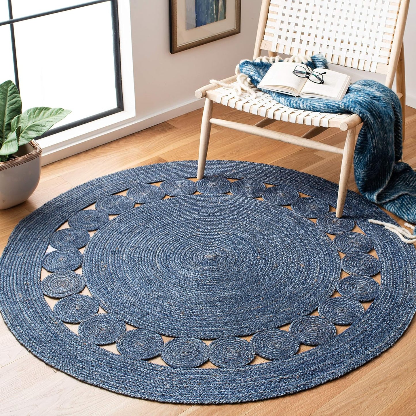 Round navy blue braided rug with decorative circular pattern, perfect for modern home decor.