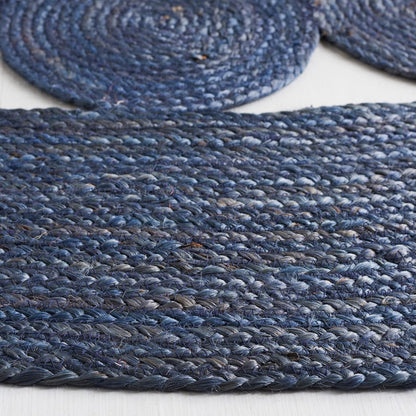 Navy blue braided jute rug, made from natural fibers, adds a textured touch to any space.
