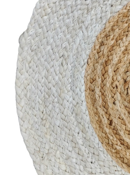 Close-up of two woven circular mats, one white and one beige, on a white background.