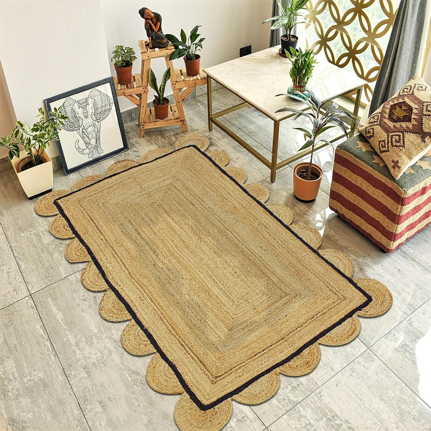 A rectangular natural jute area rug with scalloped edges and a dark border, styled in a modern living room setting on a light gray tiled floor.