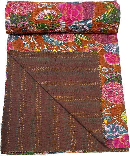 Floral patterned quilt with brown border on a white background