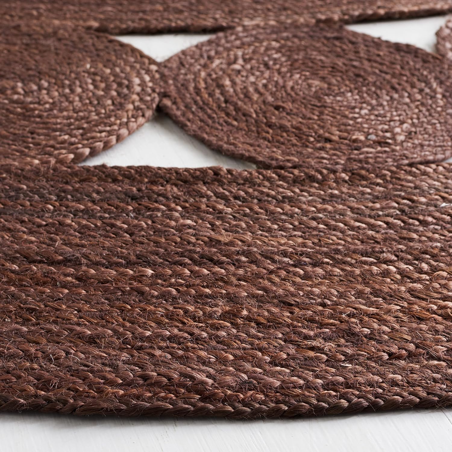 Rustic brown woven jute rug with circular and flat designs, ideal for enhancing home decor.