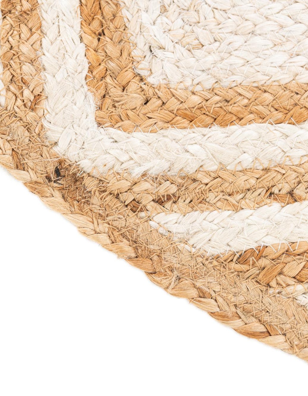 Close-up of a woven mat with natural and white stripes on a white background