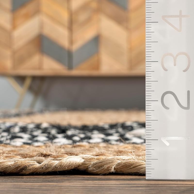 Close-up of a woven rug with a wooden cabinet in the background, featuring a ruler for scale.