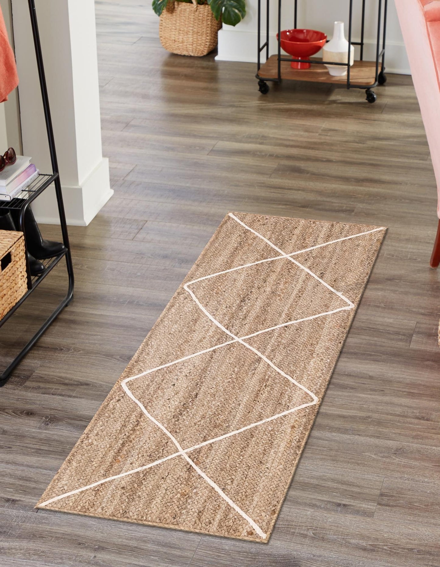 Beige runner rug with white geometric pattern on a wooden floor
