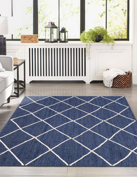 Blue geometric rug on a wooden floor with a white wall and decorative items in the background.