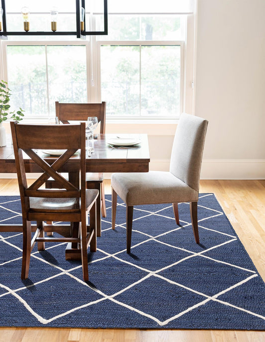 Dining room with wooden chairs, a white table, and a blue geometric rug.