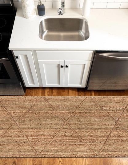 Kitchen with a rug in front of a sink and appliances