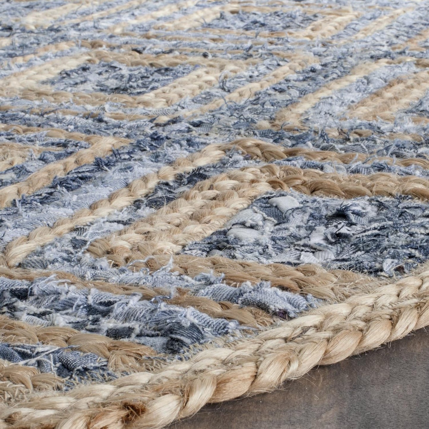 Handwoven blue and beige jute area rug with textured pattern and braided edges.