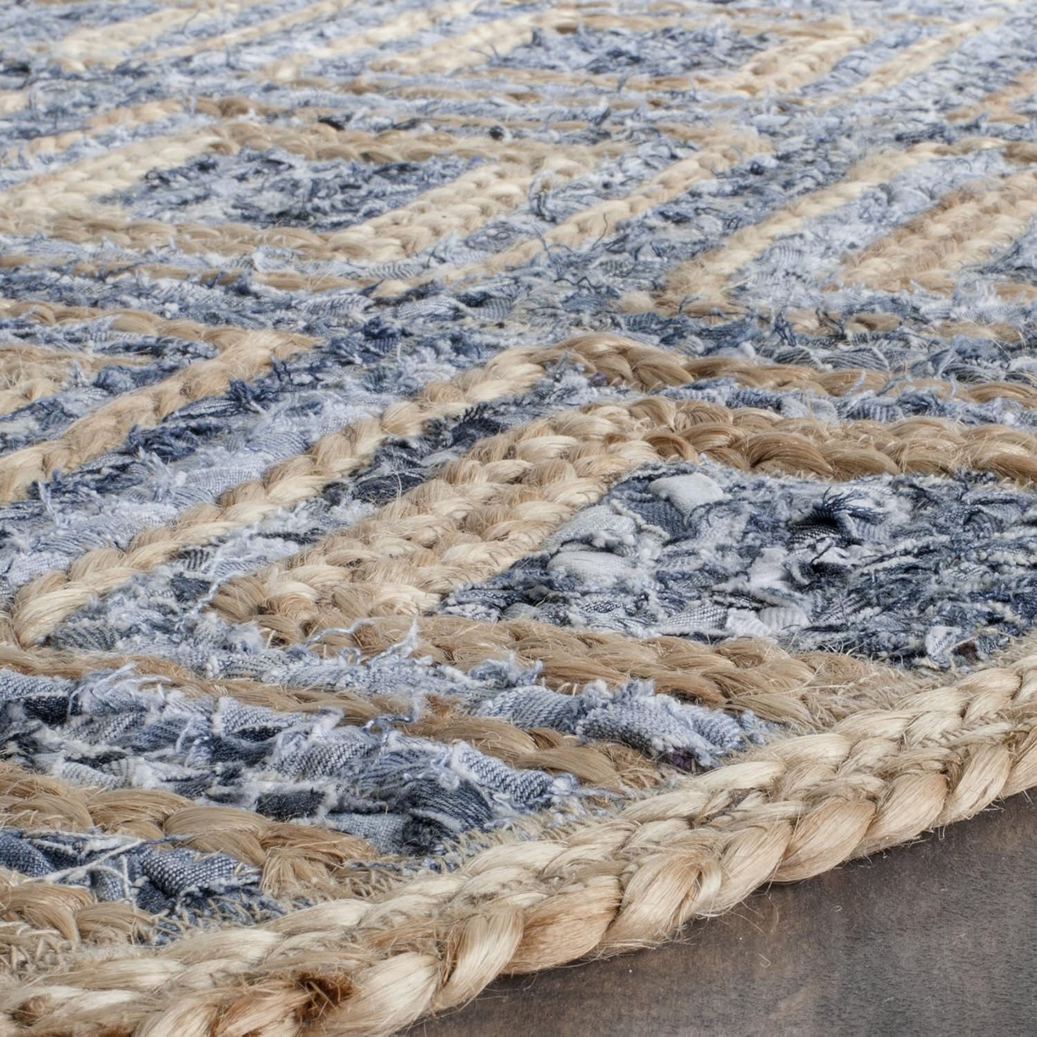 Handwoven blue and beige jute area rug with textured pattern and braided edges.
