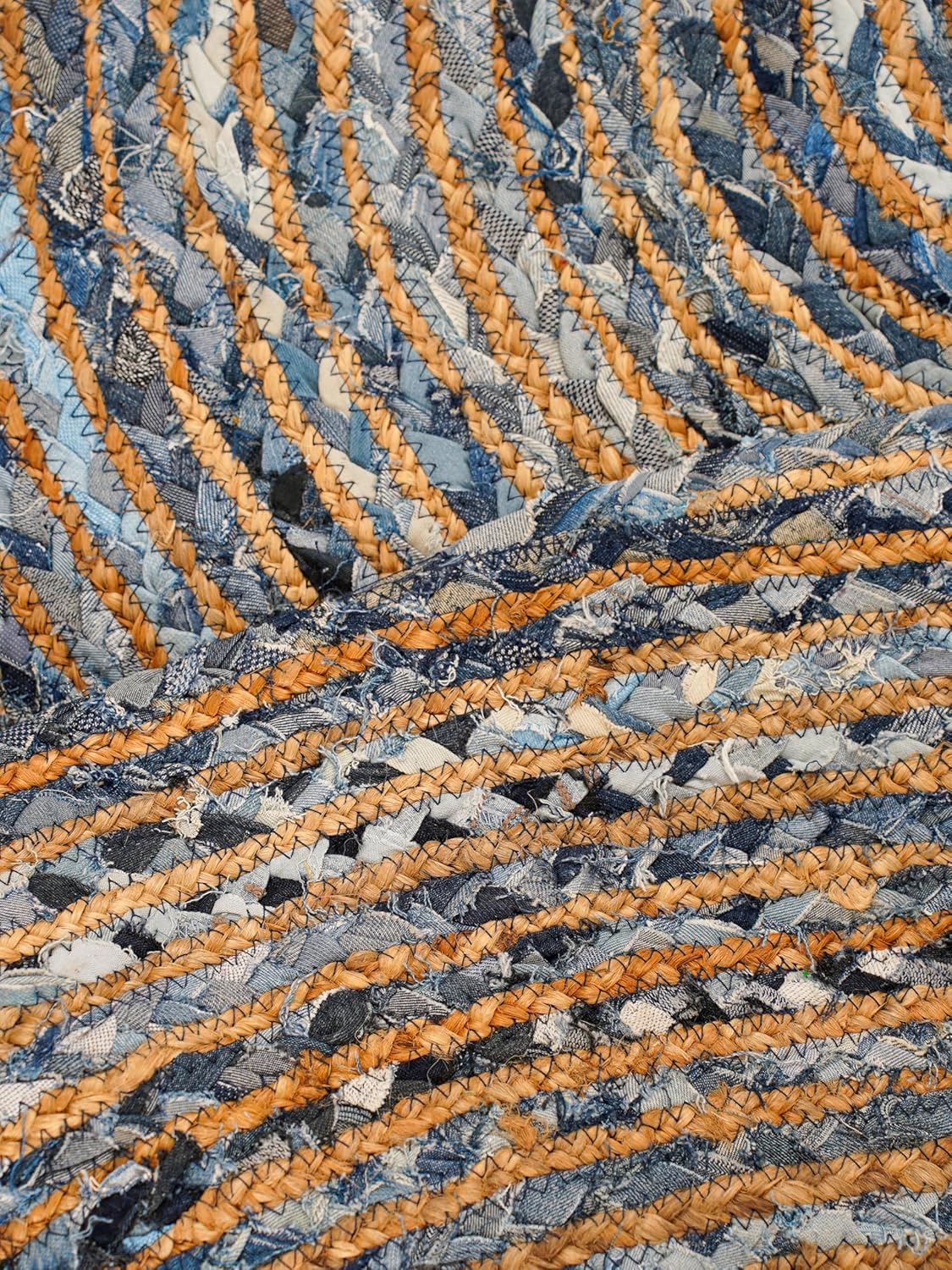 Handmade braided rug in blue and beige tones, crafted from durable fabric for a stylish home accent.
