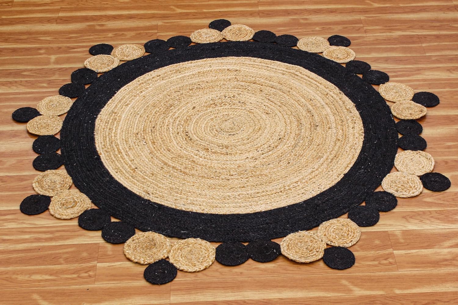 Round jute rug with black border and circular petal design, perfect for adding a rustic touch to any room.