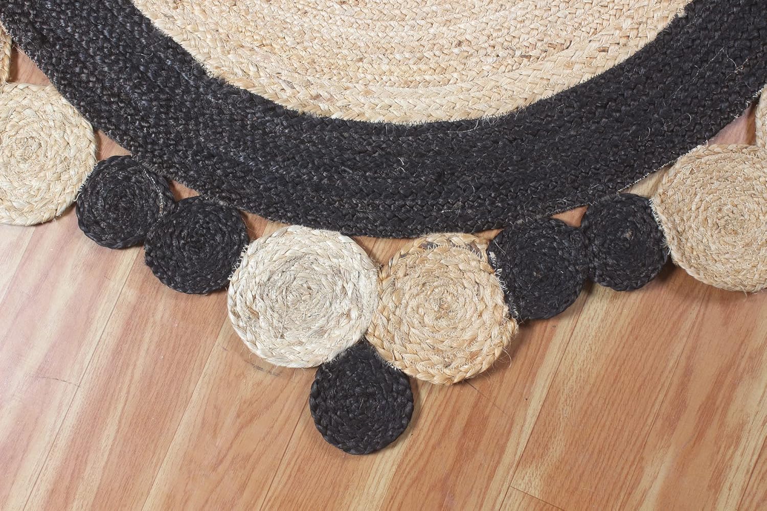 Natural Jute Area Rug in round shape with scalloped edges, featuring a blend of black and natural fibers for a textured look.