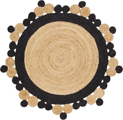 Round jute rug in natural and black colors, featuring decorative pom-pom edges for a bohemian touch.