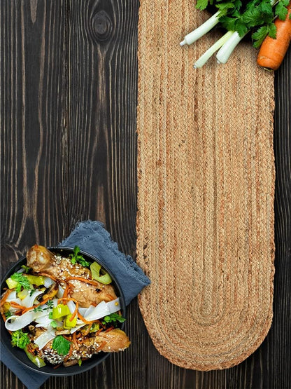 Jute mat on a wooden surface with a bowl of food and vegetables.