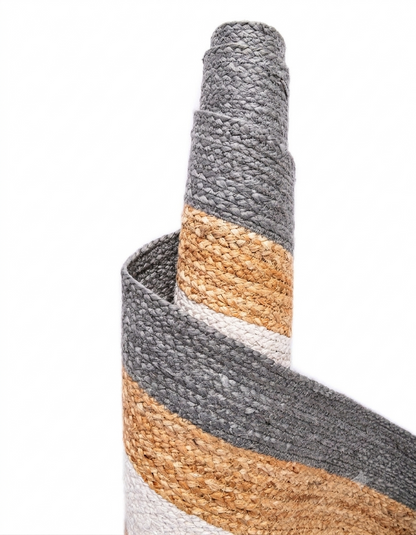 Close-up of a woven basket with gray, beige, and white stripes on a white background