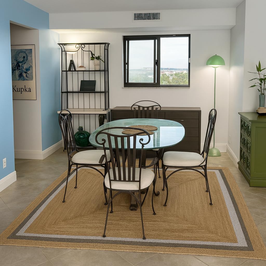 Natural Jute Area Rug in a warm beige hue, enhancing a dining area with a textured finish and subtle border detail.
