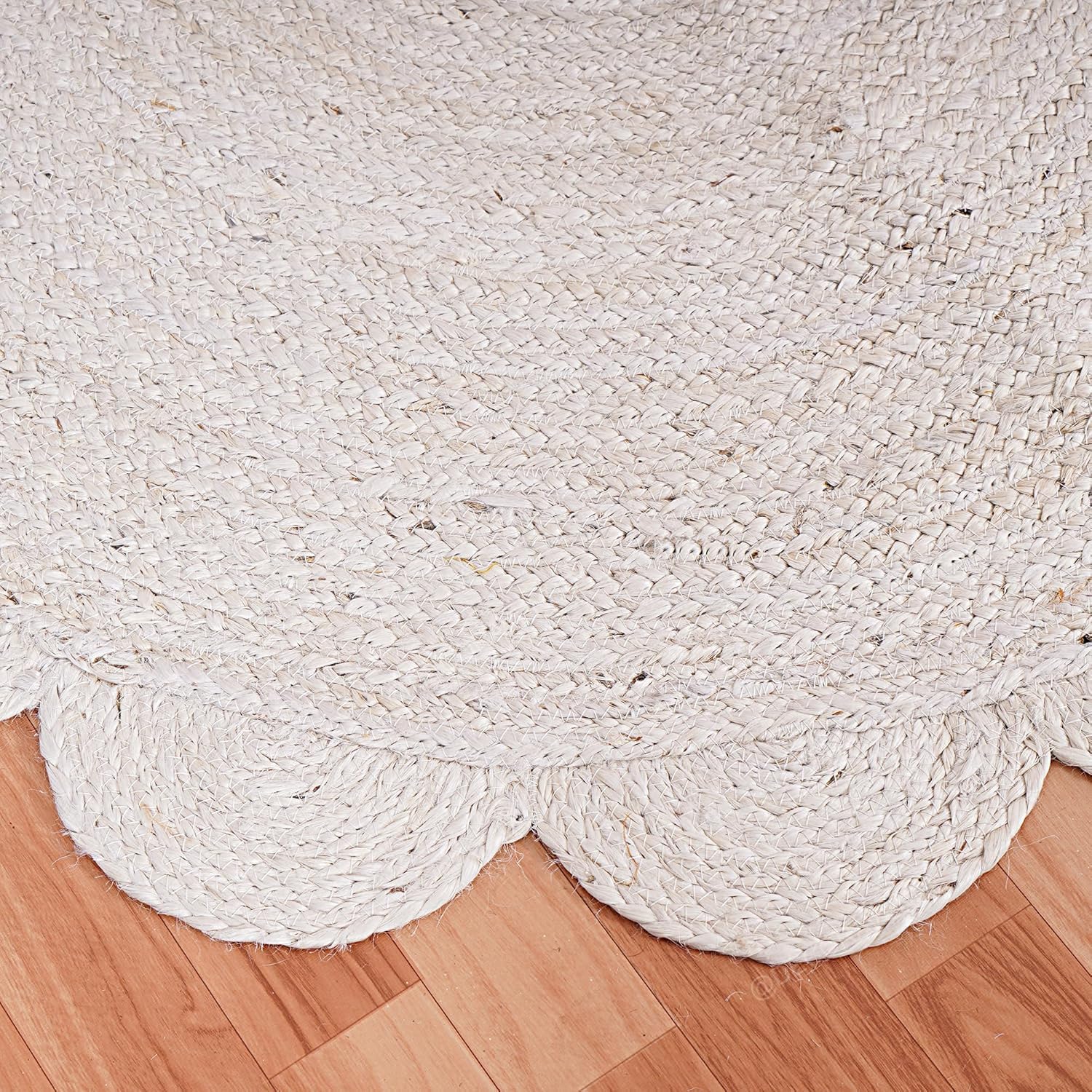 White braided rug on a wooden floor