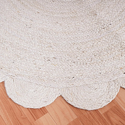 White braided rug on a wooden floor