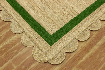 Natural Jute Area Rug with scalloped edges and a green border, perfect for adding texture to any room.