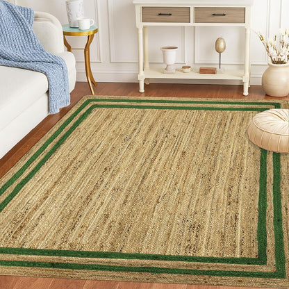 Natural Jute Area Rug with green border in a living room setting on hardwood floor next to a sofa and table.