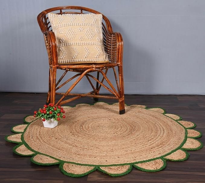 Round jute rug with scalloped edge on a wooden floor, featuring a wicker chair with a textured cushion.