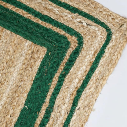 Close-up of a woven mat with green and beige stripes on a white background