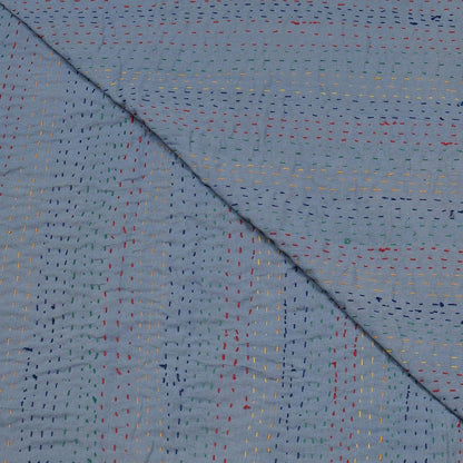 Close-up of a textured blue fabric with multicolored specks