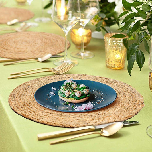Handmade round jute table placemat with natural braided texture styled on an elegant dining table setting with modern dinnerware