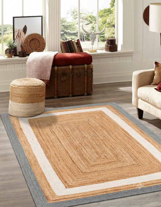 Living room with a jute rug, ottoman, and window view