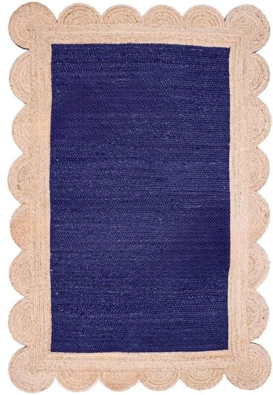 A rectangular woven rug with a deep navy blue center and a natural beige scalloped jute border, shown flat against a white background.