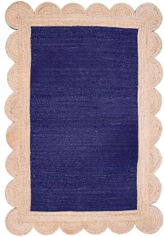 A rectangular woven rug with a deep navy blue center and a natural beige scalloped jute border, shown flat against a white background.