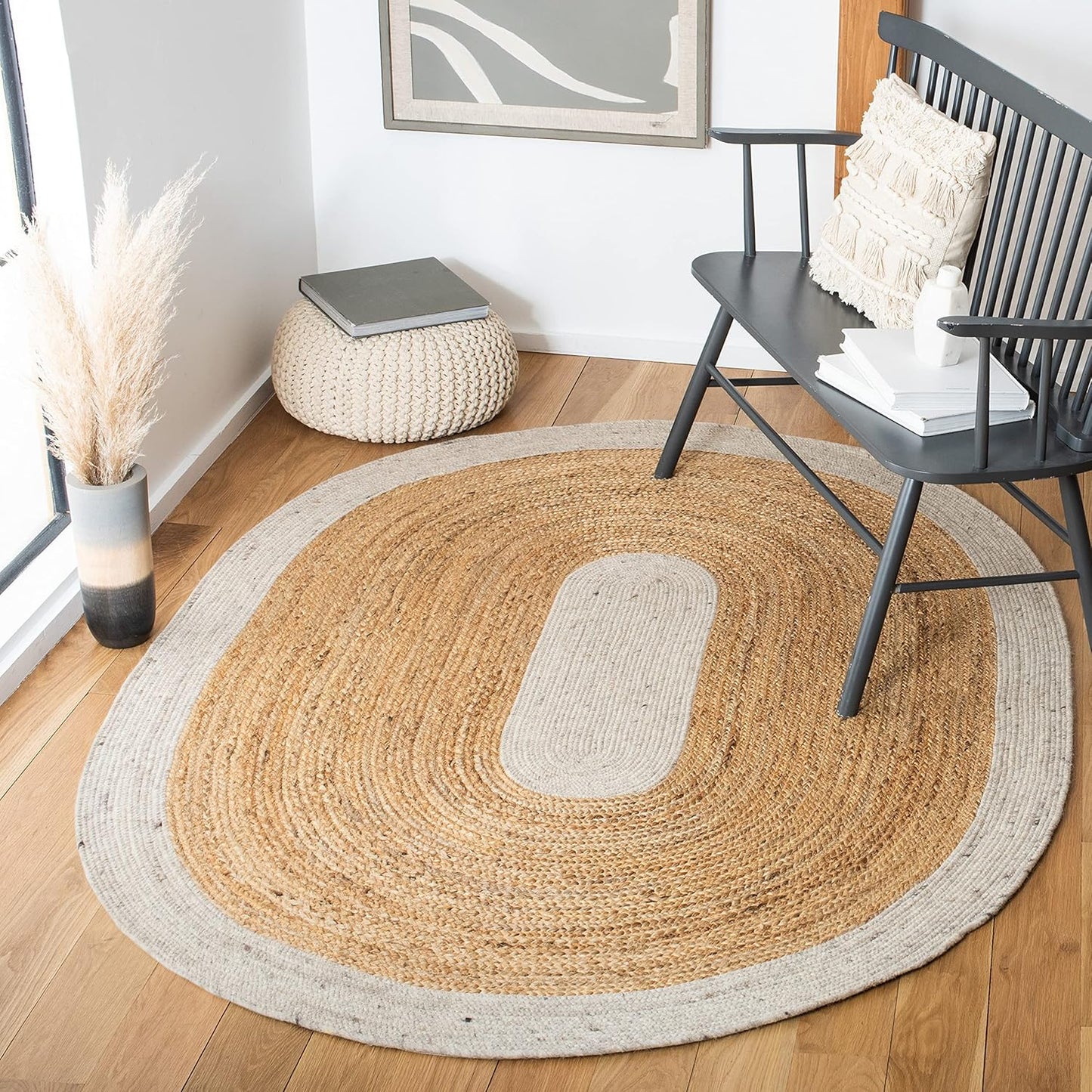 Natural woven area rug with beige and tan colors, oval shape, perfect for cozy home decor.