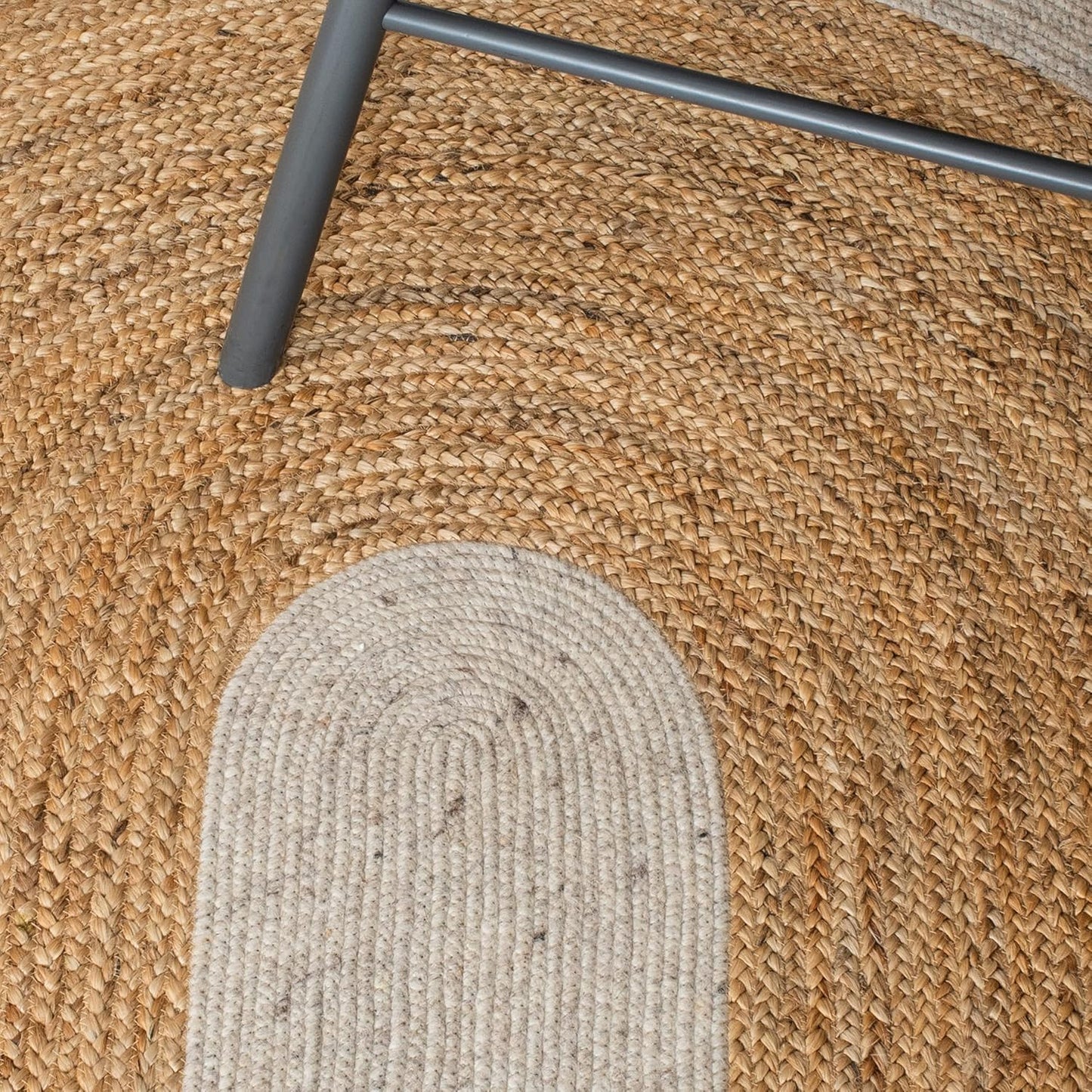Natural jute and wool area rug, round shape, featuring beige and tan tones, perfect for cozy home decor.