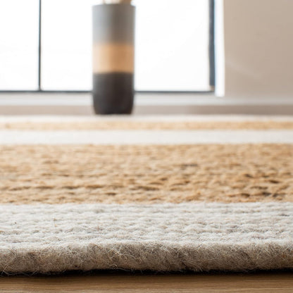 Natural woven jute area rug with beige and cream stripes, perfect for modern home decor.
