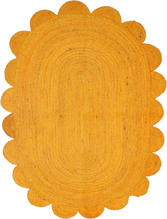 Yellow braided rug with scalloped edge on a white background