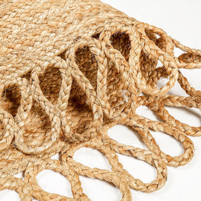 Natural Jute Area Rug with intricate braided edges — a stylish floor carpet made from eco-friendly materials.